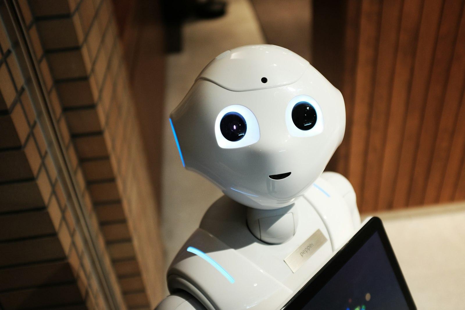 A small white robot with expressive eyes